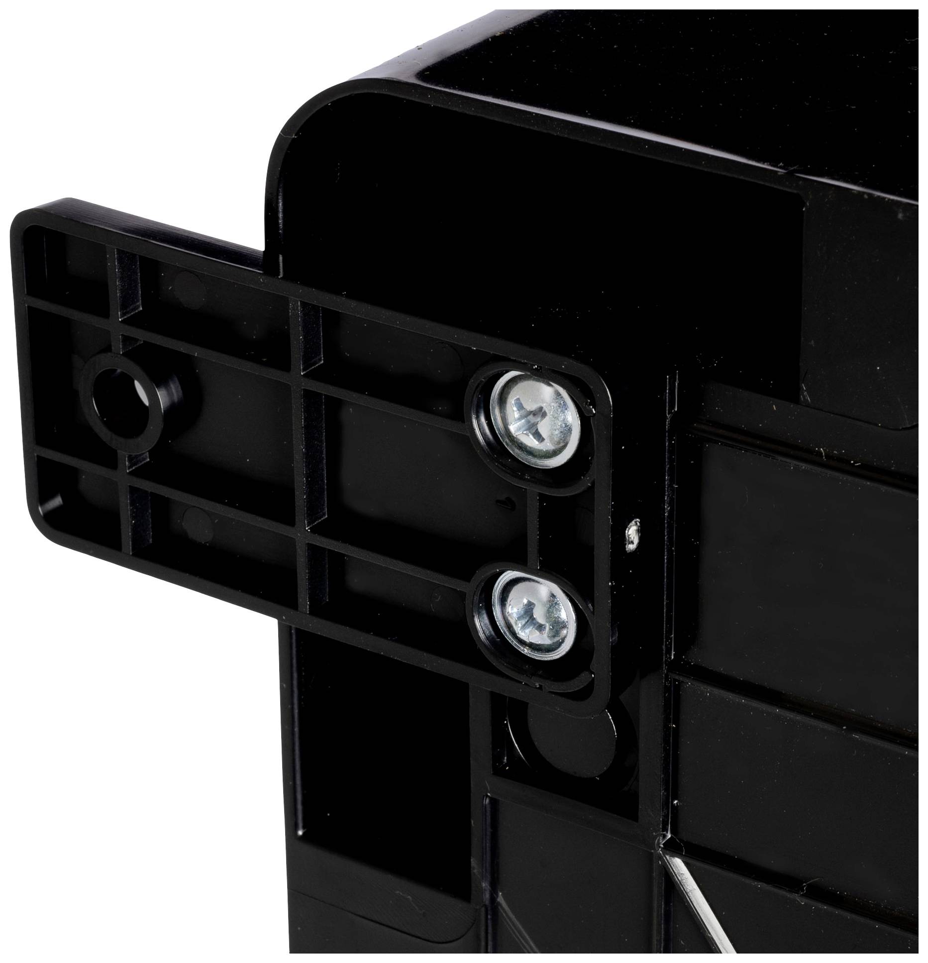 A black plastic component with two visible screws on the left side is attached to a larger structure.