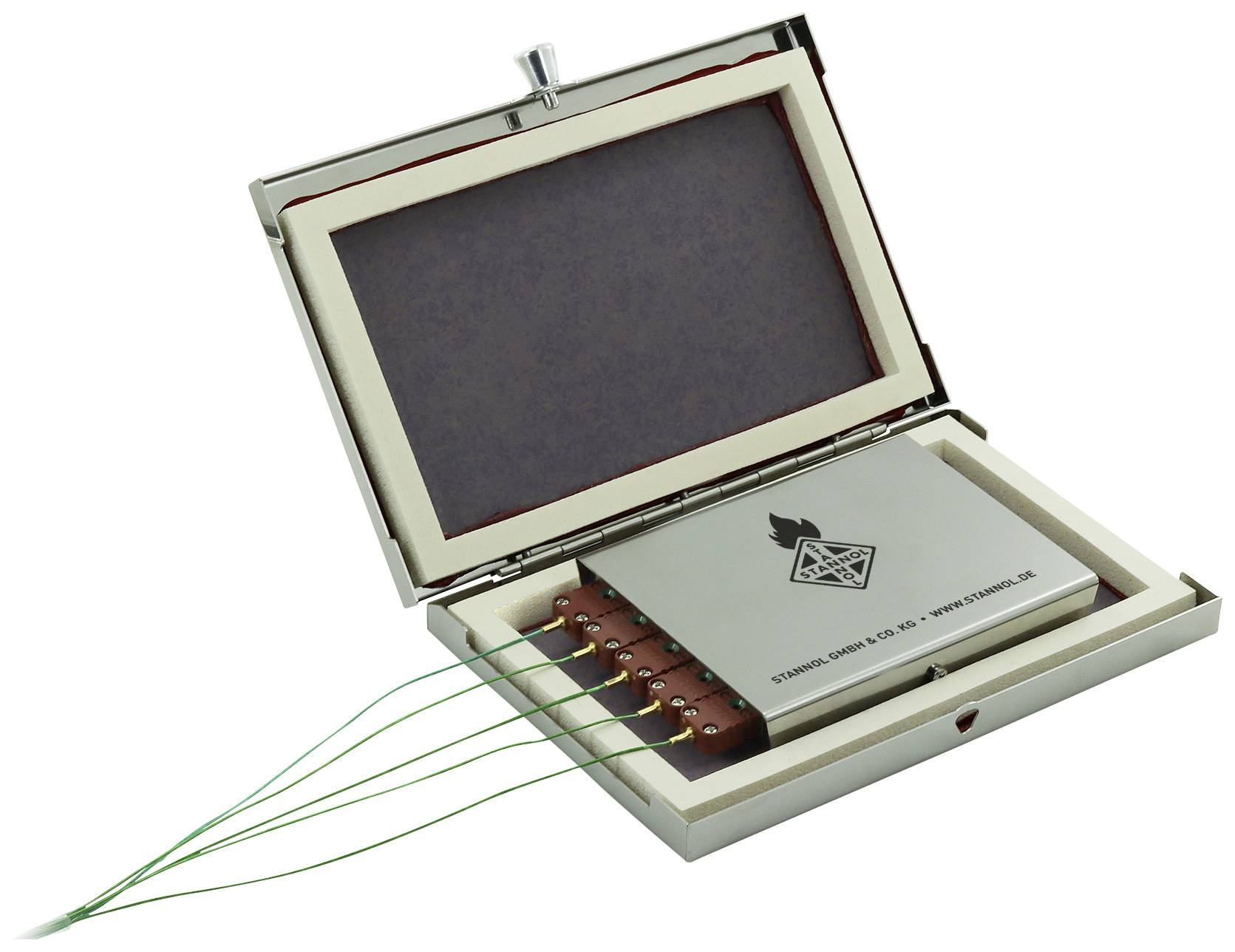 Metal box with an open lid, containing an electronic device with six green cables. Longer text on the device not legible.