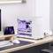 White desktop PC with transparent side panel reveals internal hardware and purple lighting, sits on modern desk next to monitor.