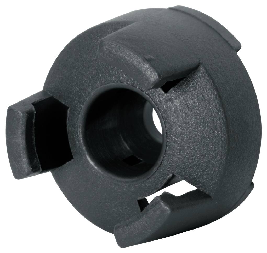 Black, precisely shaped mechanical component with multiple slots, presumably part of a coupling or connection system.