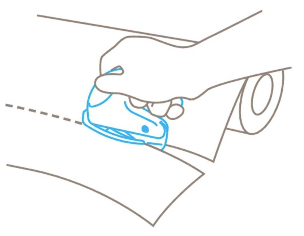 Sketch of a hand using a small cutting tool to cut paper from a roll along a dotted line.