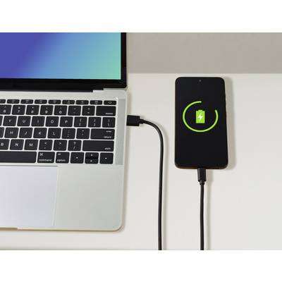 A smartphone is being charged via a cable from a laptop. A charging symbol is visible on the smartphone screen.