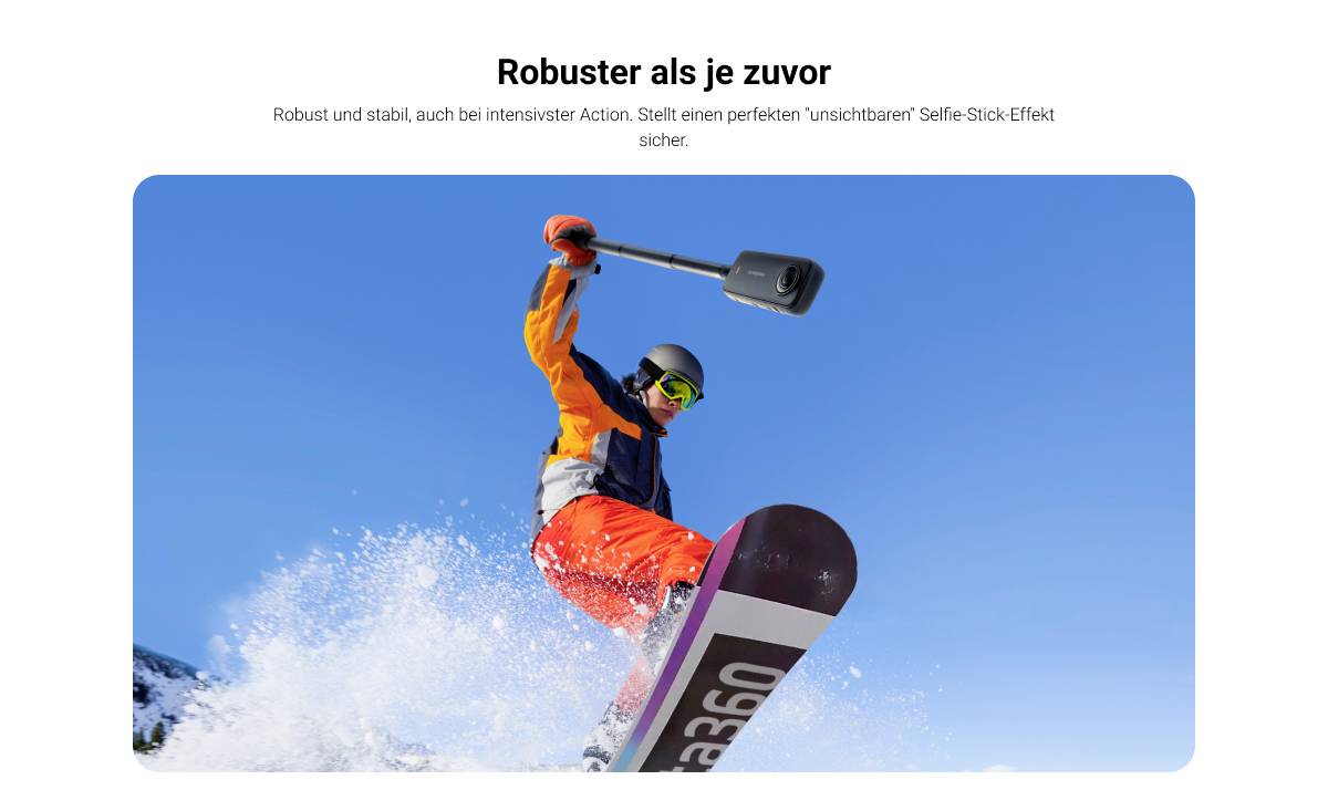 A snowboarder in orange gear performs a tricky movement mid-jump, photographed from a low angle against a clear, blue sky.
