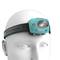 A head model wears a turquoise head torch mounted on a flexible, black headband.