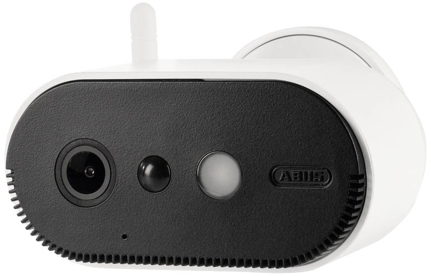 White surveillance camera with a black front and three lenses, placed on a table, background not visible.