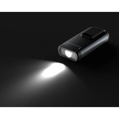 Torch illuminates against a dark background. It has a compact design and emits a powerful beam of light.