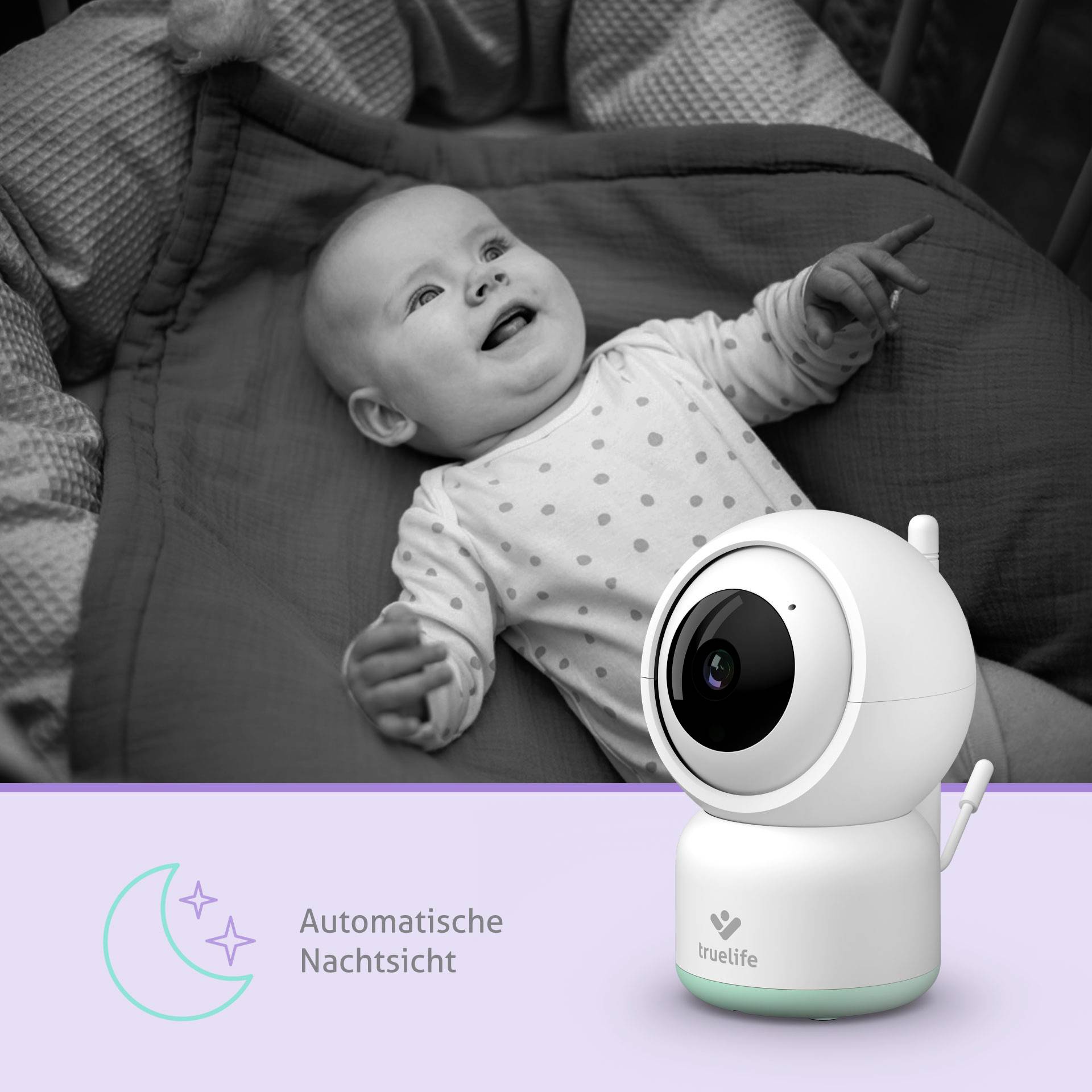 A baby on a bed smiles and reaches upwards. In the foreground is a camera with the label 'Automatic Night Vision'.