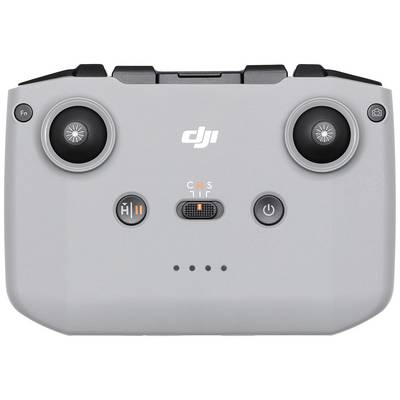 Grey drone remote control with two control sticks, multiple buttons and a rotary switch in the centre, marked with 'C', 'N', 'S'.