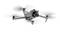 A white quadcopter drone is flying in the air. It has a camera on the front for aerial photography and surveillance.
