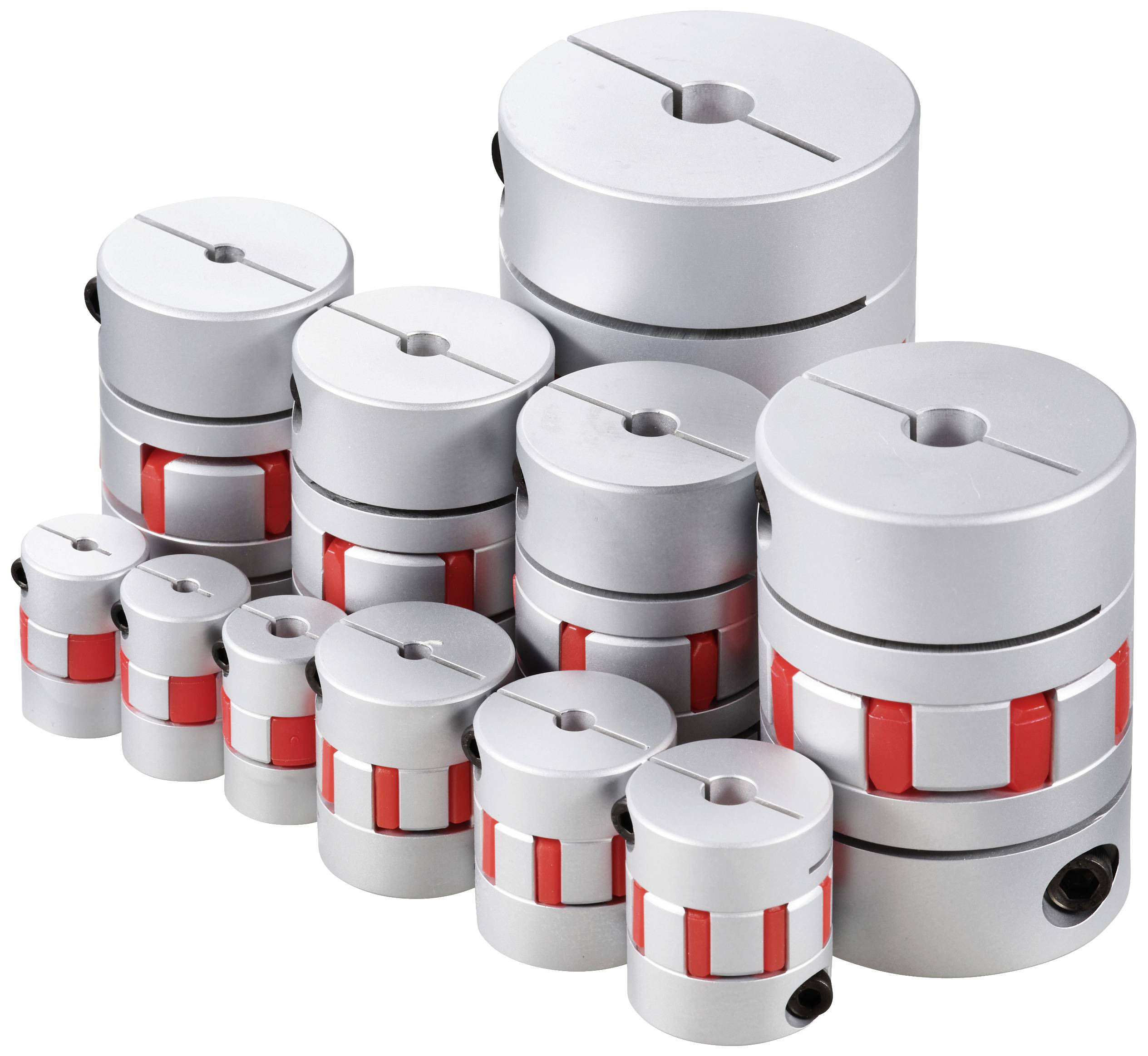 Various sizes of silver-metallic coloured couplings, some with red elements, stacked on a surface, industrial accessories.