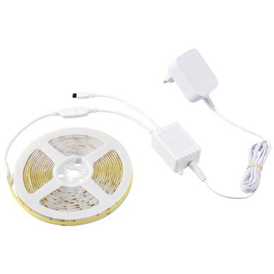 LED light strip on a reel, connected to a power supply. Suitable for decorative lighting in interior spaces.
