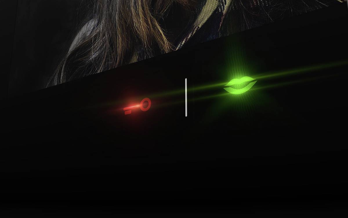 'Image of a red key and a green leaf on a black background. The key glows red, the leaf glows green.'