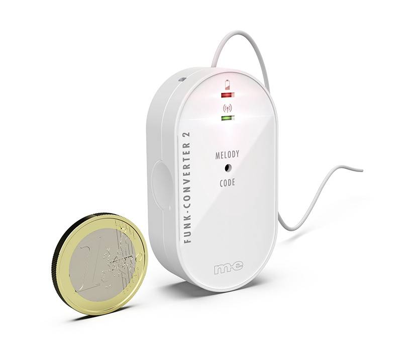 A wireless device with the label 'Radio Converter 2' placed next to a one-euro coin for size comparison.