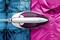An iron glides over jeans and a pink shirt, demonstrating its ironing function on different fabrics.