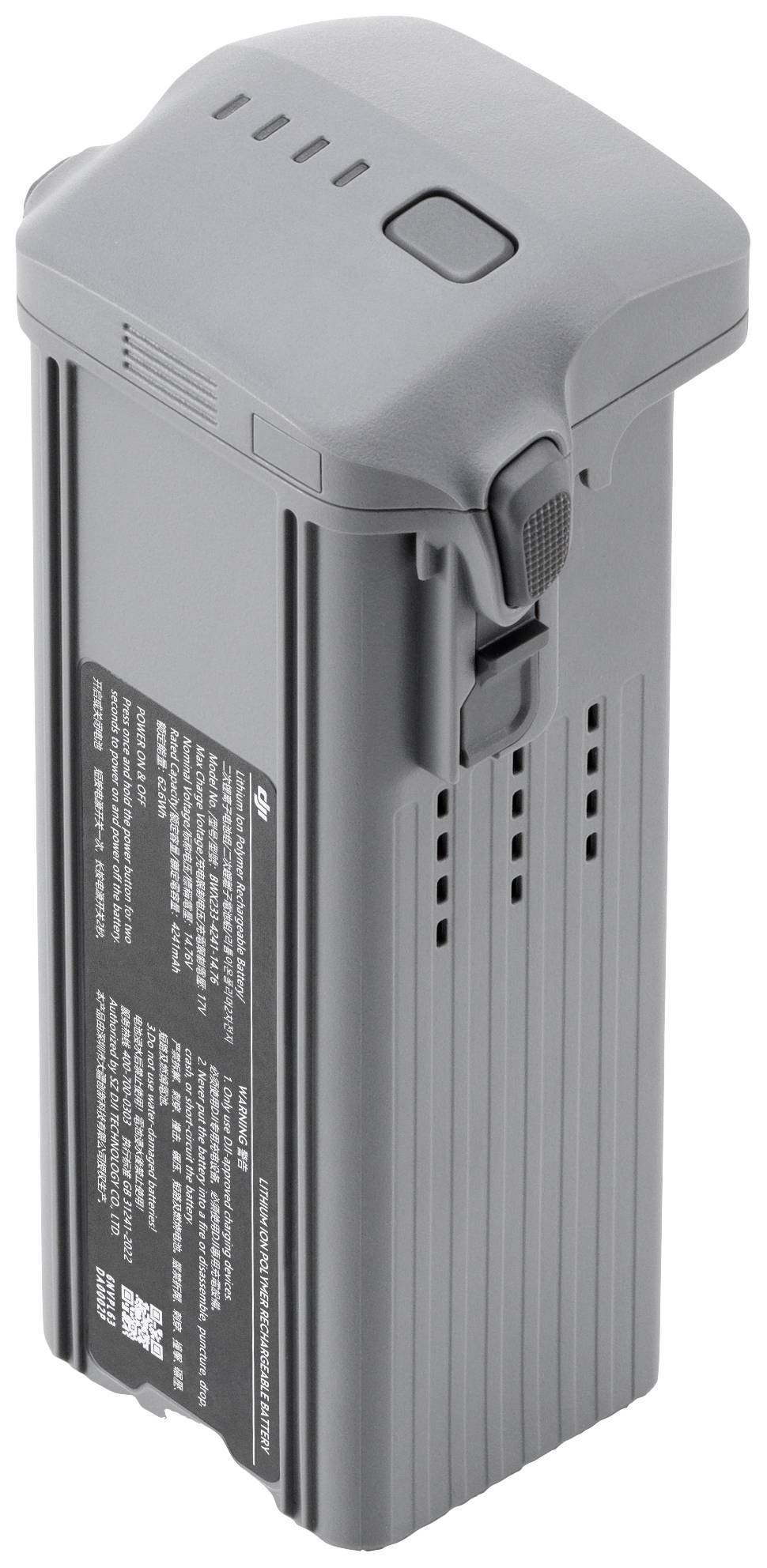 Grey drone battery with a black label and inscription, rectangular in shape with a snap fastener on top.