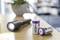 Torch on table with two batteries beside it, ready for use. A plant is blurrily visible in the background.