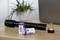 Two purple batteries with the inscription 'ANSMANN 6500', beside a dismantled torch on a wooden table.