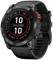 A black smartwatch with a round display shows the time '10:10'. Markings such as 'Steps' and 'Battery' are visible on the bezel.