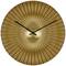 A golden wall clock with a radial pattern and black hands indicates the time.