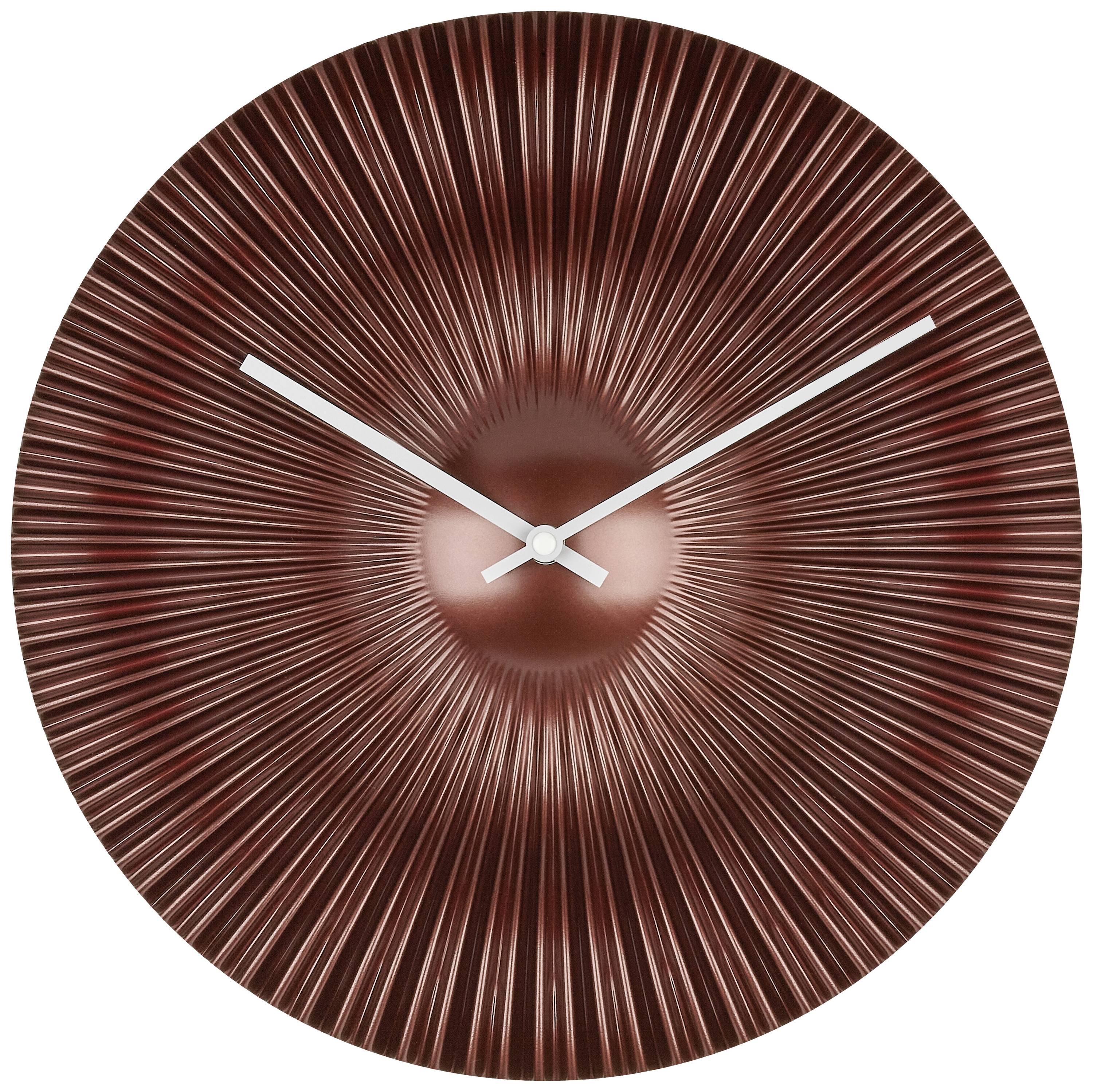 Round wall clock with radial lines in copper finish and silver hands.