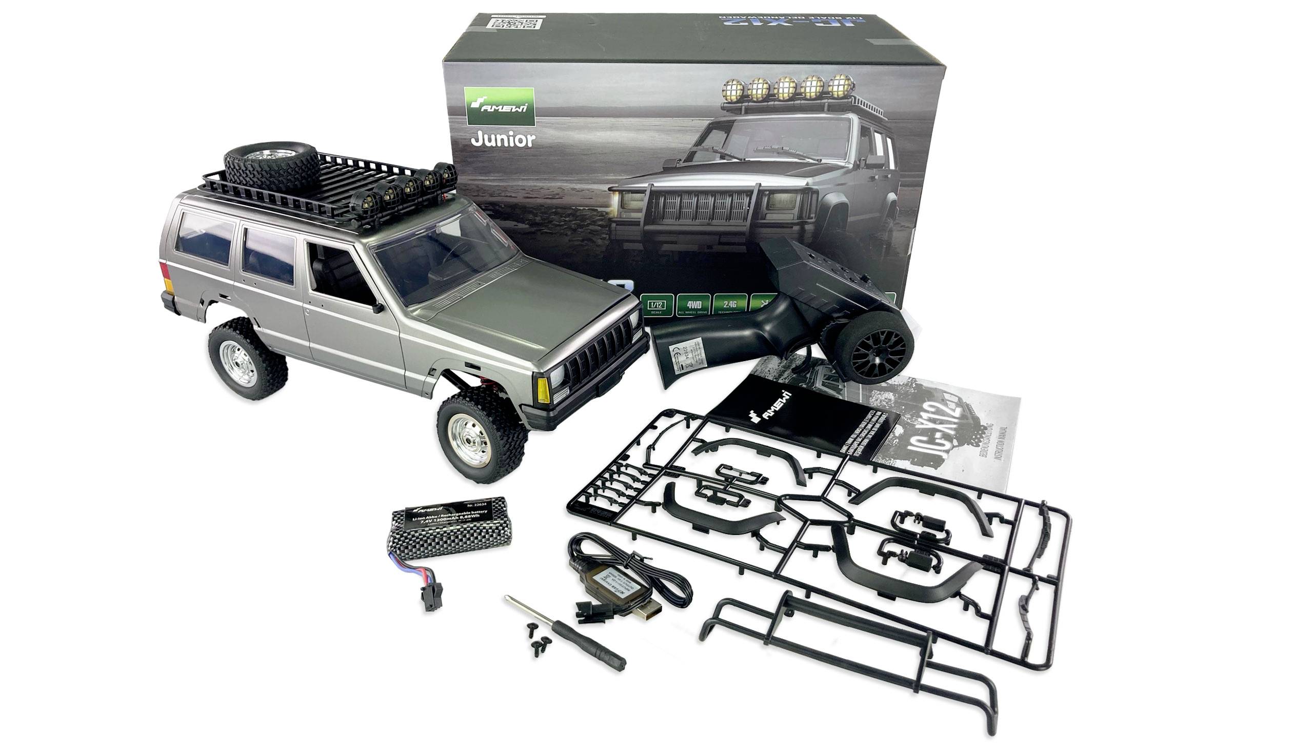 Model car kit of a silver off-road vehicle with accessory parts and packaging, showing the completed car on the box.