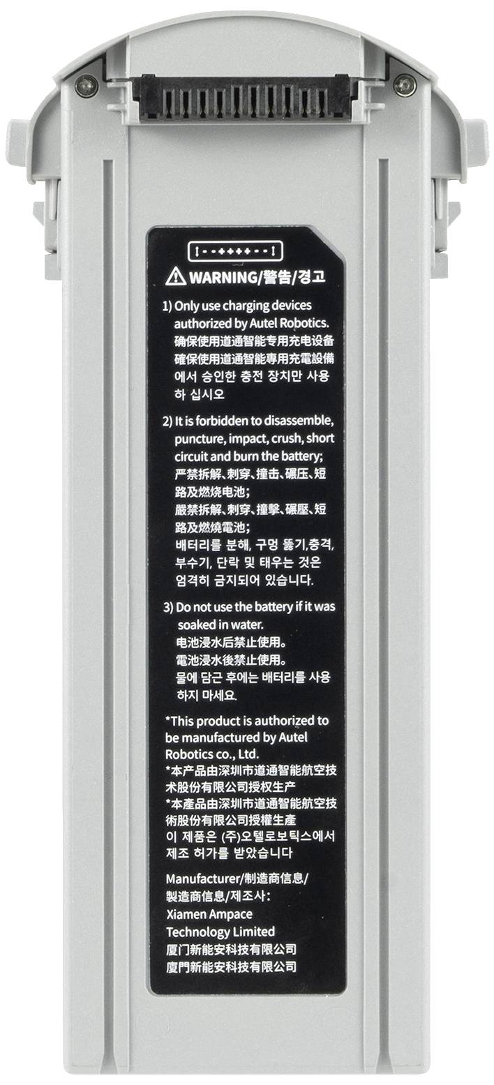 Grey battery pack with a vertical warning notice in multiple languages, listing safety regulations and charging instructions.