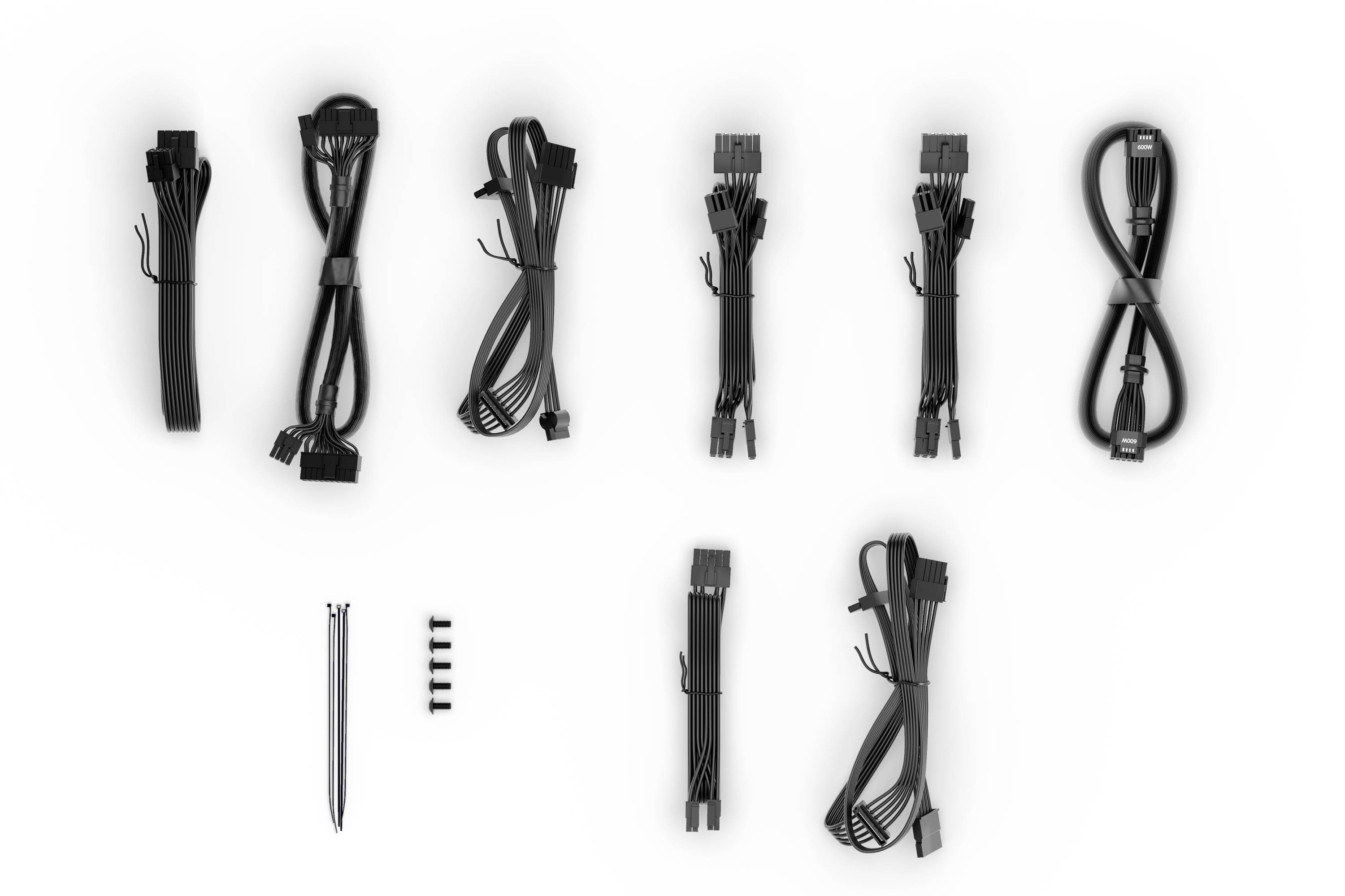 Diverse black computer cables and accessories, arranged on a white background. Different connection types visible.