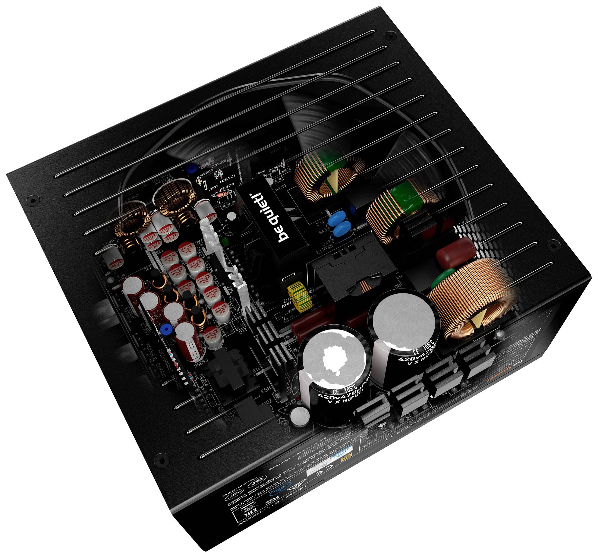 PC power supply from above: view of internal components such as capacitors, inductors and heatsinks. 'be quiet!' branding visible.