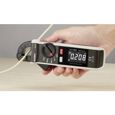 A hand is holding a digital clamp meter against a cable, displaying a reading of 0.208 amperes on the screen.