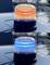 'Two sirens on a car roof. The upper siren is orange, the lower one blue. Both sirens are reflected on the glossy surface.'
