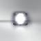 A single, luminous LED chip on a reflective surface, surrounded by a soft glow in neutral grey.