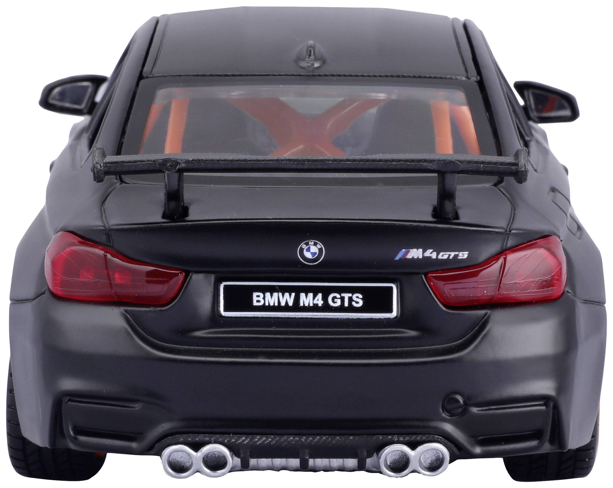 A black BMW M4 GTS viewed from behind, with a distinctive rear spoiler and four exhaust pipes, parked under a clear sky.