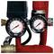 Two pressure gauges on red and black piping, showing readings in bar and psi; larger left gauge around 4 bar, smaller right gauge around 2 bar.<br>