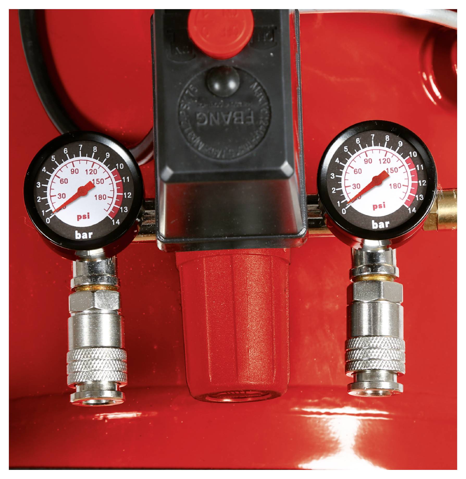 Close-up of two pressure gauges on a red air compressor or regulator, each showing pressure in psi and bar.