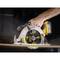 A hand is holding a cordless circular saw cutting through a wooden board. Sawdust is flying around.