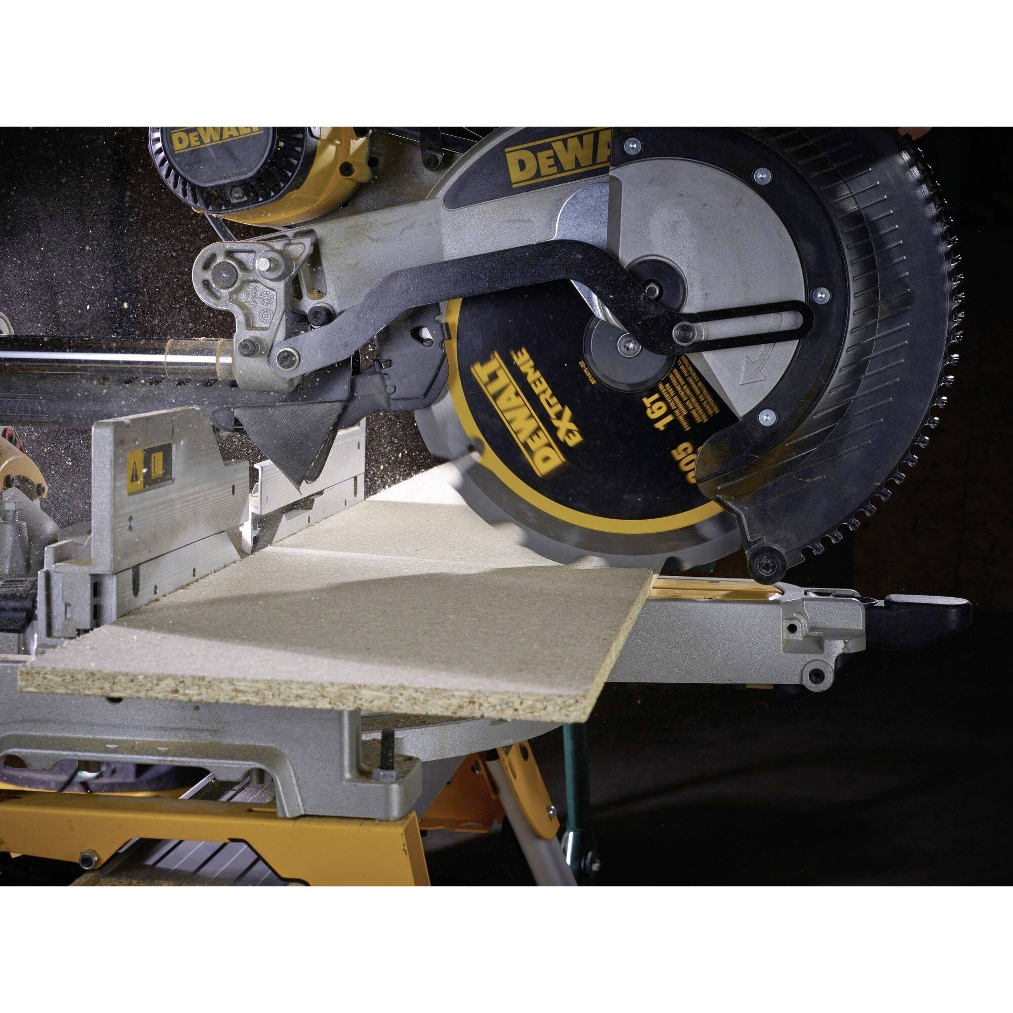 'Circular saw cutting a wooden board. Close-up shows the machine in operation, dust particles visible in the air.'