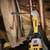 'Close-up of a construction worker using a drill to bore a hole into a wooden beam. Sparks are flying through the air.'