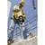 A construction worker wearing a hard hat and safety glasses is using a drill on a building site. Scaffolding and a crane are visible in the background.
