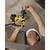 A person wearing a safety helmet is drilling into a concrete ceiling with an electric hammer drill.
