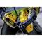 A person is wearing yellow gloves and holding a yellow and black cordless saw while inserting a battery.
