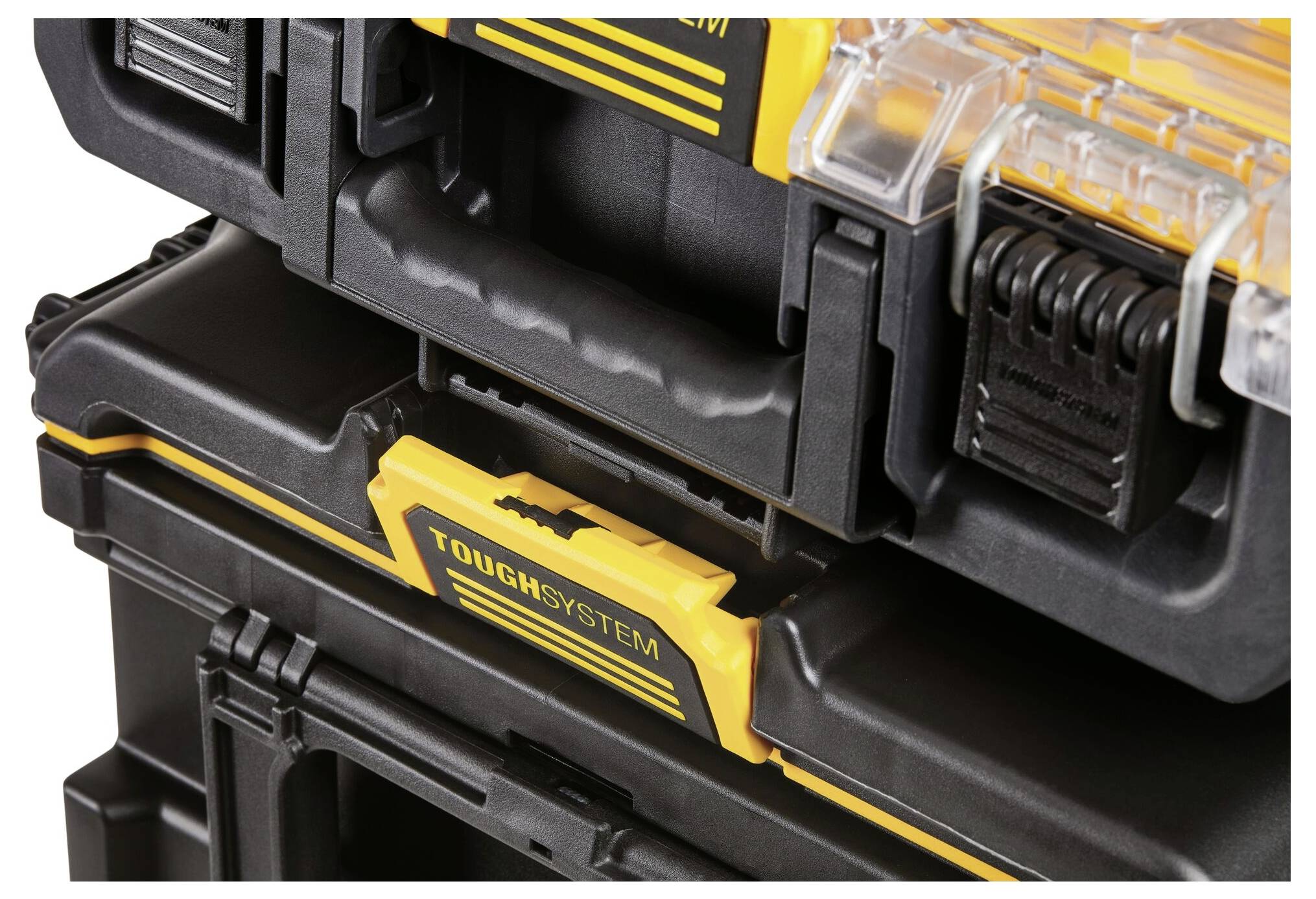 Black, stackable toolbox with a robust handle and yellow accents, marked with 'TOUGHSYSTEM', for transporting and storing tools.