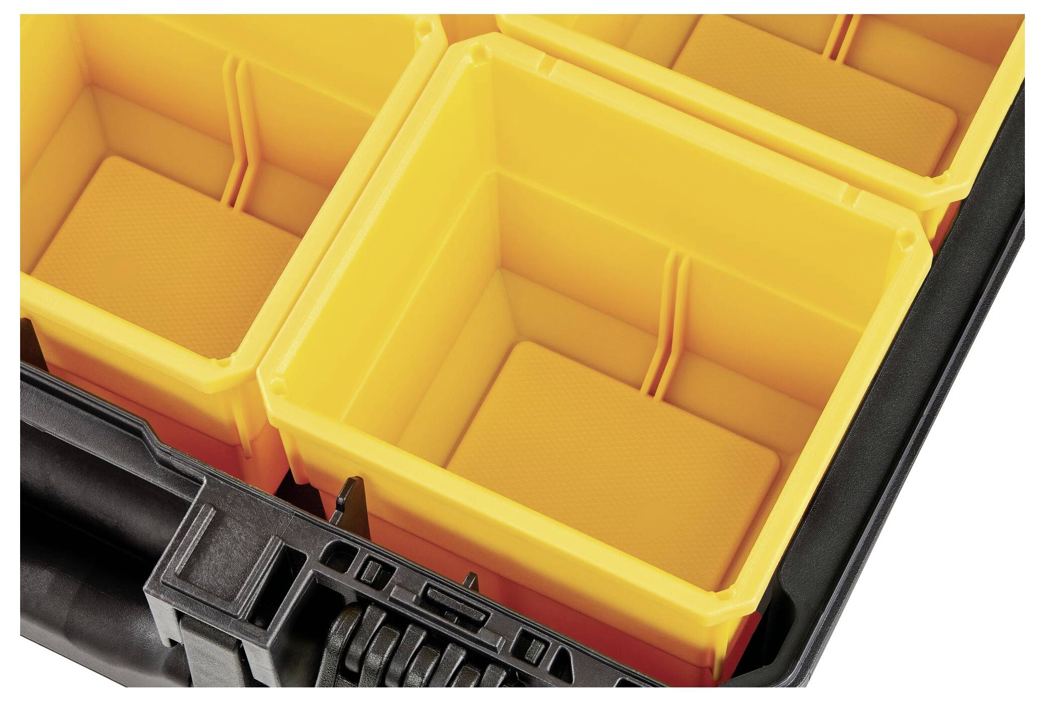 An opened toolbox with yellow, empty compartments for storing smaller items or tools.