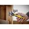 A hand is holding an adjustable spanner to tighten a screw in a wooden board. The spanner is coloured yellow and black.