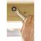 A hand tightens a screw with a spanner on a wooden frame.