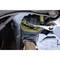 A hand in a work glove is holding a spanner and tightening a bolt on a vehicle.