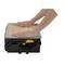 A person is pressing down on the lid of a toolbox to close it. The box is black with a yellow fastener.