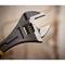 Adjustable spanner with measurement scale, close-up view. Tool used for gripping or turning nuts and bolts.