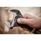 A hand holds an adjustable spanner, which is being opened to grip a screw or nut. Background out of focus.