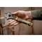 A hand is holding an adjustable spanner in a workplace environment. The spanner is marked with the inscription 'Stanley Fatmax'.