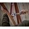 A person is using an adjustable spanner to tighten a screw on a metal ladder.